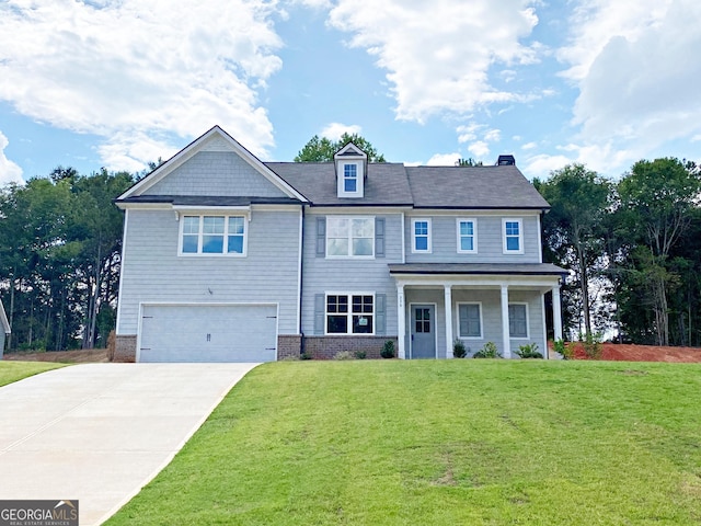 view of front of home featuring a front yard and a garage