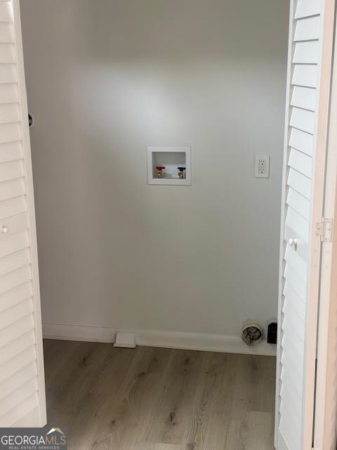 washroom featuring hookup for a washing machine and hardwood / wood-style flooring