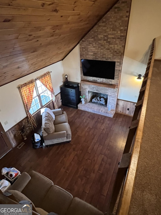 living room with wood ceiling, lofted ceiling, a fireplace, and hardwood / wood-style floors