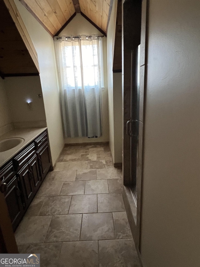 bathroom featuring vaulted ceiling, sink, and wood ceiling