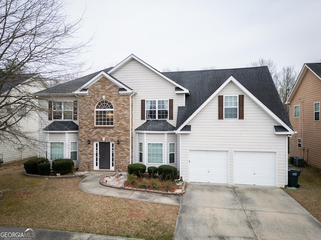 front of property featuring central AC and a garage