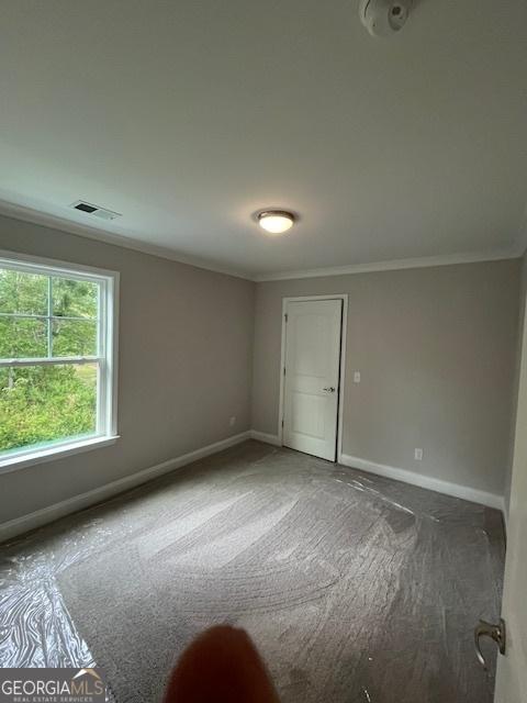 carpeted spare room with ornamental molding