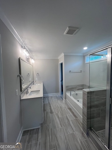 bathroom with shower with separate bathtub, crown molding, and vanity