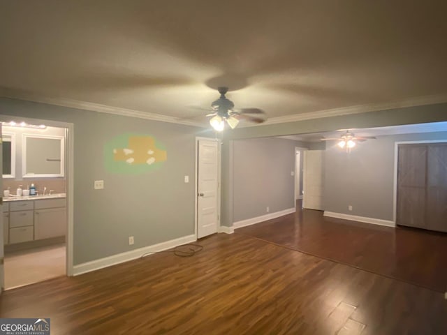 unfurnished bedroom with ensuite bathroom, ornamental molding, ceiling fan, and dark hardwood / wood-style floors