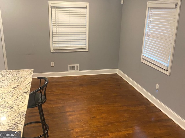 unfurnished dining area featuring dark hardwood / wood-style floors