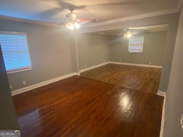 empty room with ceiling fan, dark hardwood / wood-style flooring, and crown molding