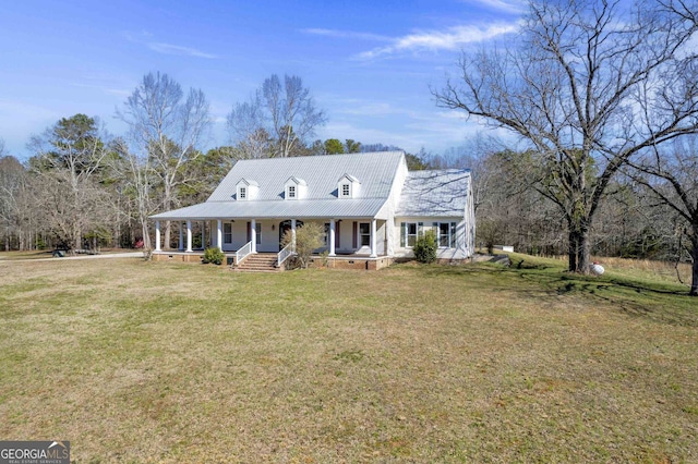 cape cod house featuring a porch and a front yard