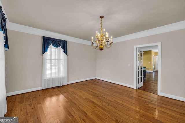 unfurnished room with a chandelier, crown molding, and dark wood-type flooring