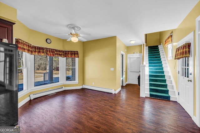 interior space with a baseboard radiator, ceiling fan, and dark hardwood / wood-style flooring