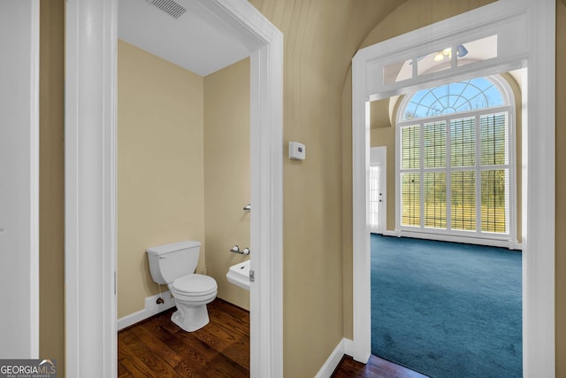 bathroom featuring toilet and hardwood / wood-style flooring