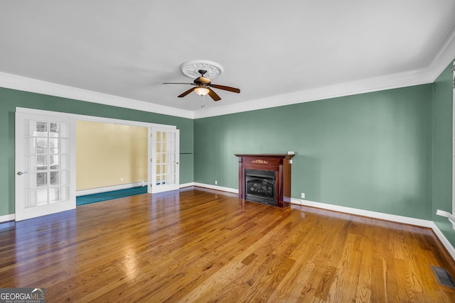 unfurnished living room featuring crown molding, ceiling fan, and light hardwood / wood-style flooring