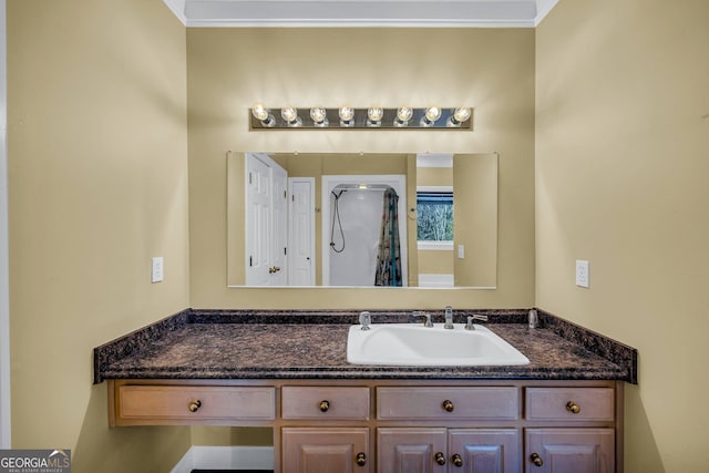 bathroom with ornamental molding and vanity