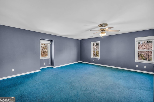 carpeted spare room featuring ceiling fan