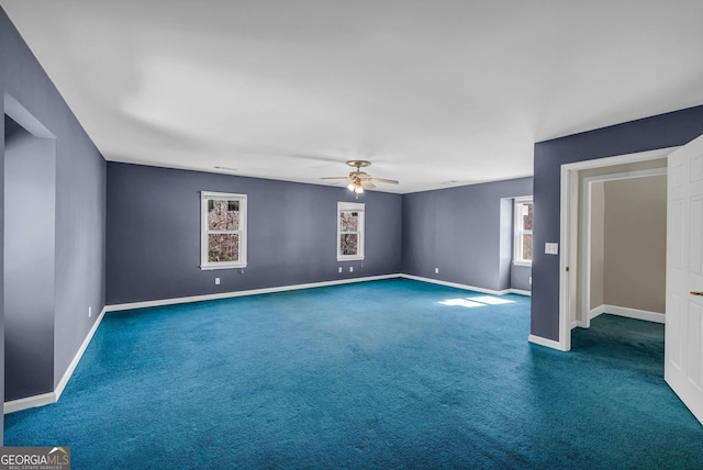 carpeted spare room featuring ceiling fan