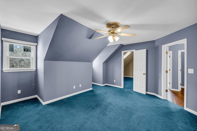 bonus room featuring dark colored carpet, ceiling fan, and vaulted ceiling