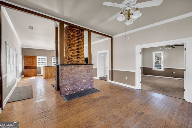 unfurnished living room with ceiling fan, a wealth of natural light, and light hardwood / wood-style floors