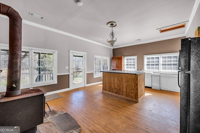 kitchen featuring dishwasher, ornamental molding, black fridge, and light wood-type flooring