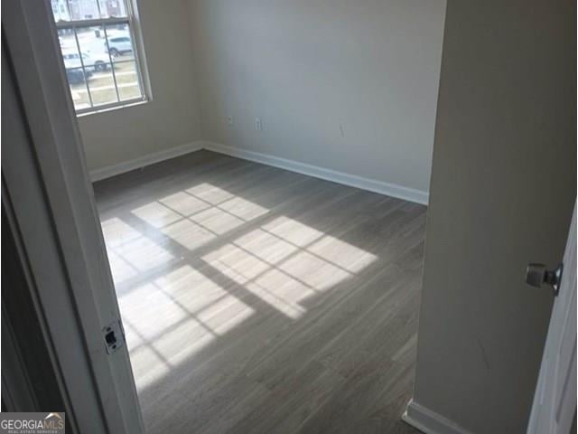 unfurnished room with light wood-type flooring