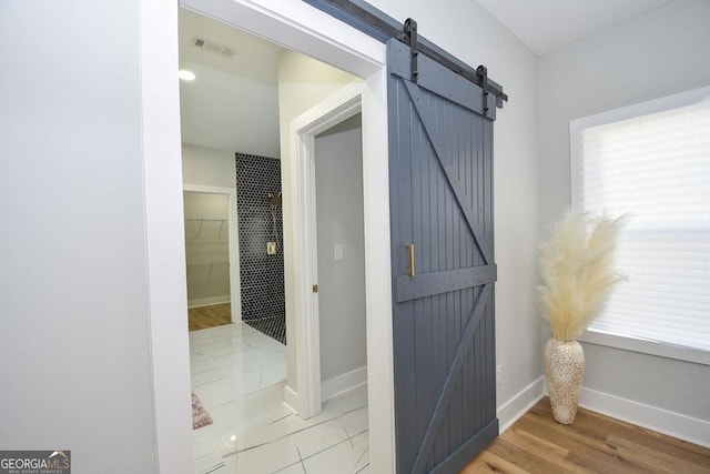 interior space with a barn door and light tile floors