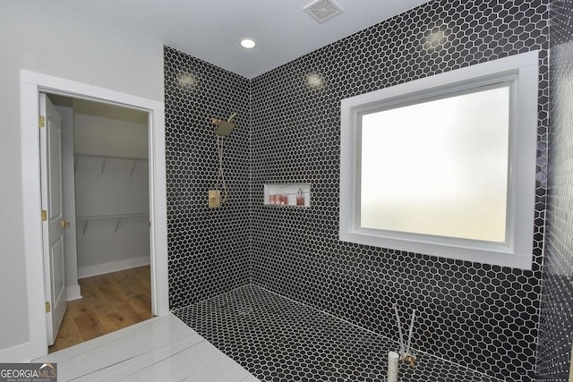 bathroom featuring tile walls and hardwood / wood-style flooring