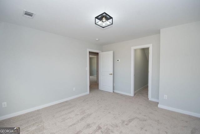 unfurnished bedroom featuring light carpet