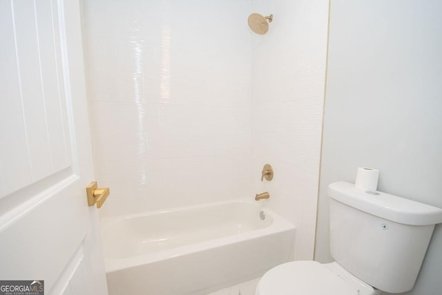 bathroom featuring toilet and bathing tub / shower combination