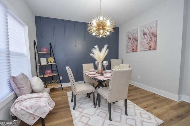 dining room with a notable chandelier and light wood-type flooring