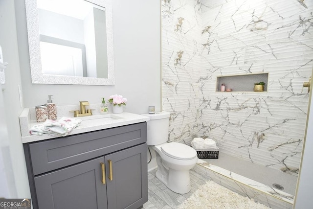 bathroom featuring vanity, tile floors, and toilet