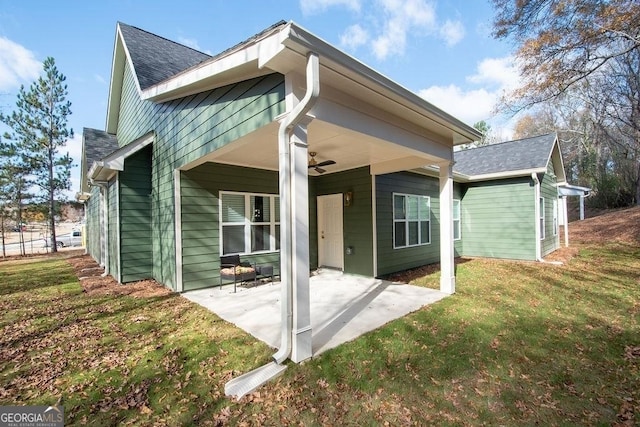 rear view of property with a lawn and a patio area