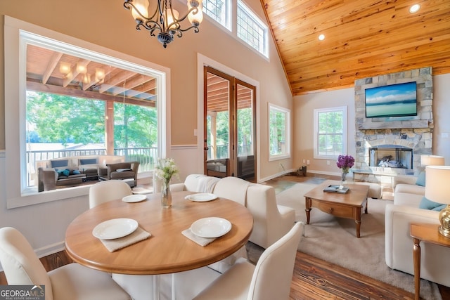 228 Harris Rd, Jackson, GA 30233 - dining room featuring a fireplace, wooden ceiling, a chandelier, hardwood / wood-style floors, and high vaulted ceiling