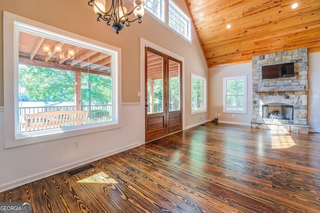 228 Harris Rd, Jackson, GA 30233 - unfurnished living room featuring wood ceiling, high vaulted ceiling, wood-type flooring, and a stone fireplace