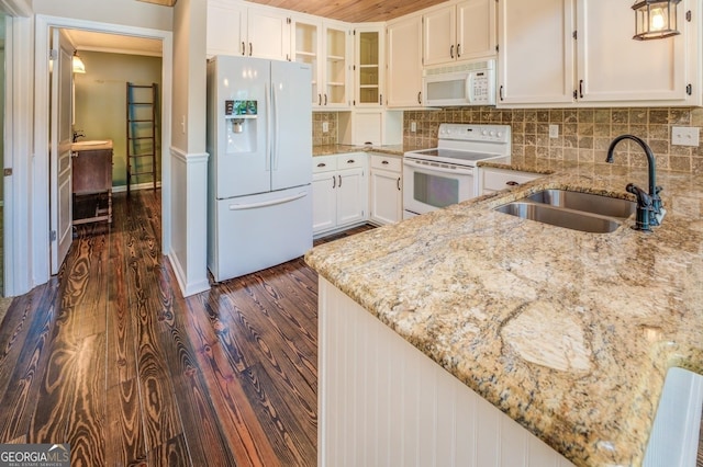 228 Harris Rd, Jackson, GA 30233 - kitchen with light stone countertops, dark hardwood / wood-style flooring, white appliances, sink, and tasteful backsplash
