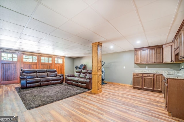 228 Harris Rd, Jackson, GA 30233 - living room featuring decorative columns, a paneled ceiling, and light wood-type flooring