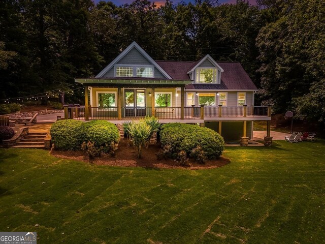 228 Harris Rd, Jackson, GA 30233 - back house at dusk with a yard and a deck