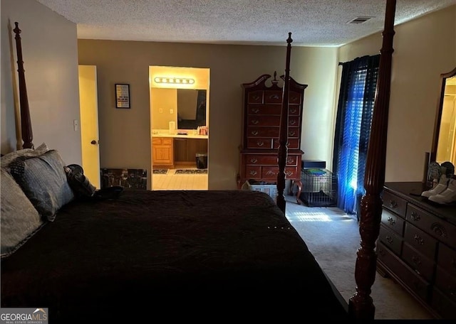 bedroom featuring carpet flooring, connected bathroom, and a textured ceiling