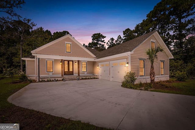 view of front facade with a garage and a porch