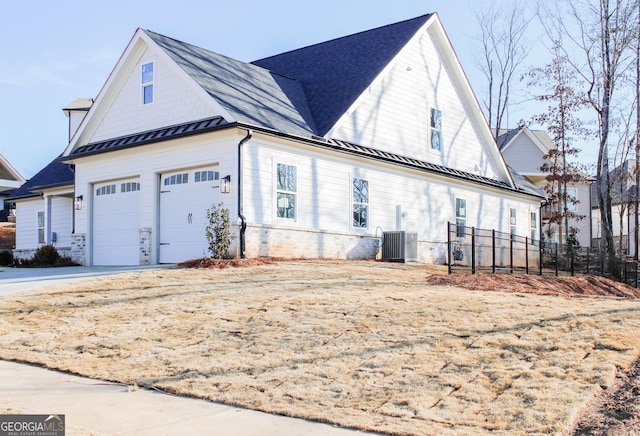 view of side of home with central AC