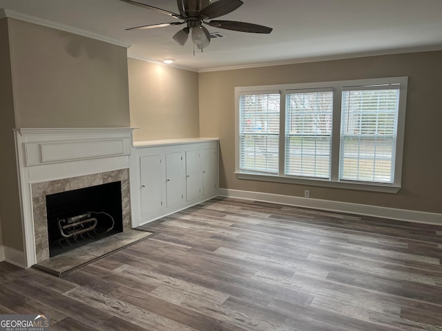 unfurnished living room with ceiling fan, dark wood-type flooring, and ornamental molding