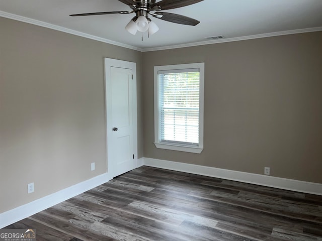 empty room with dark wood-type flooring, ornamental molding, and ceiling fan