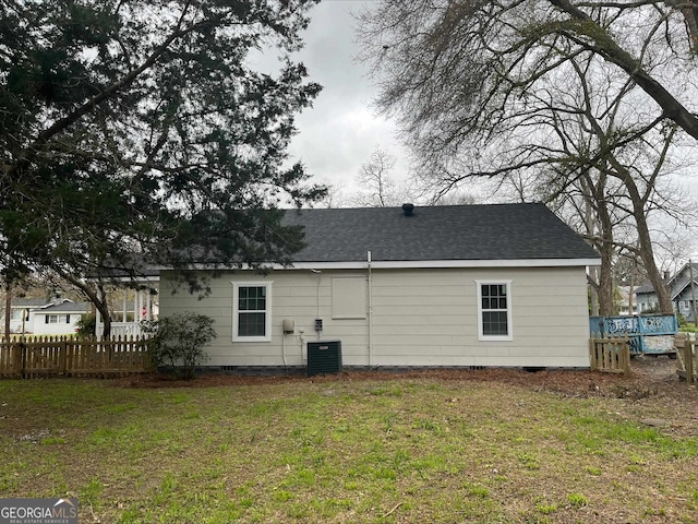 back of house featuring a lawn, a deck, and central air condition unit