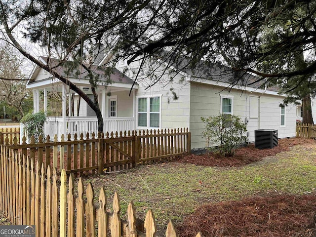 exterior space with central AC unit and a porch