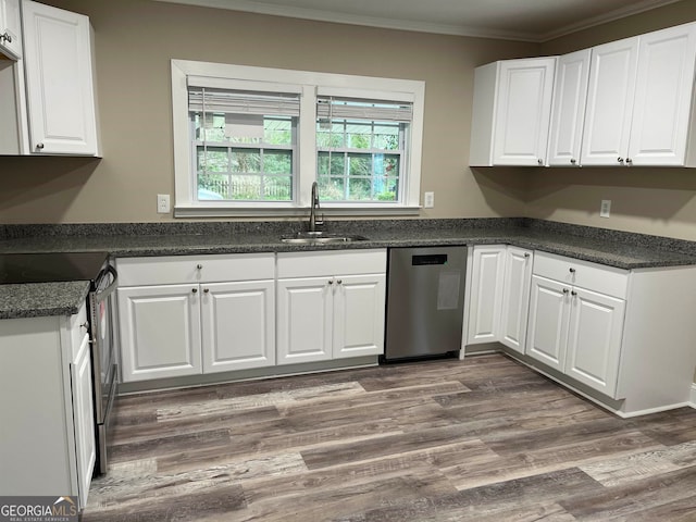 kitchen with appliances with stainless steel finishes, crown molding, white cabinets, sink, and dark hardwood / wood-style flooring