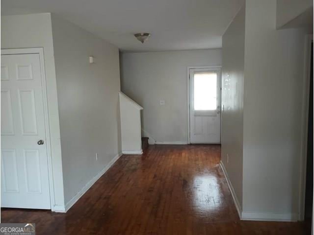 corridor featuring dark wood-type flooring