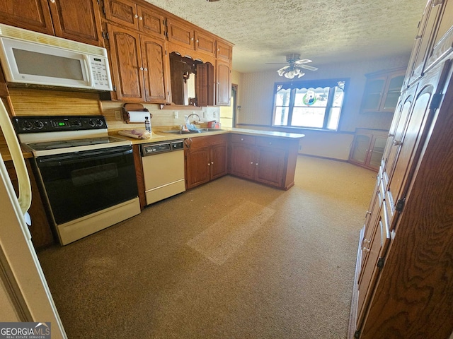 kitchen with ceiling fan, white appliances, sink, a textured ceiling, and light colored carpet