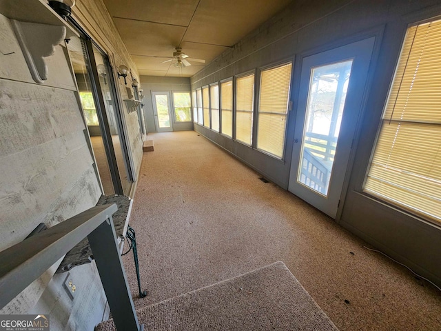 hallway featuring light colored carpet