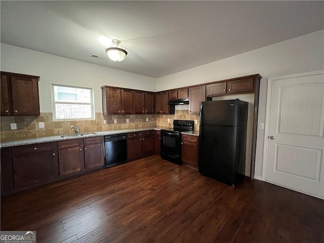 kitchen featuring sink, tasteful backsplash, dark hardwood / wood-style floors, and black appliances