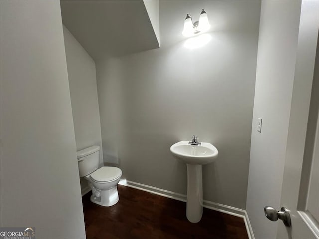 bathroom with toilet and wood-type flooring