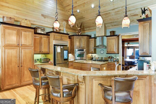 kitchen with light stone countertops, stainless steel appliances, lofted ceiling, pendant lighting, and a kitchen island