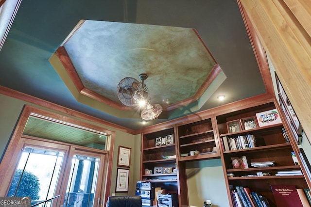 interior details featuring crown molding and a raised ceiling