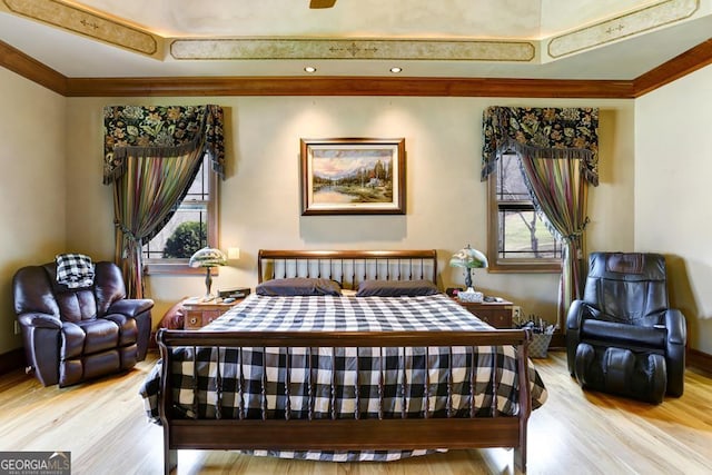 bedroom featuring light wood-type flooring and crown molding